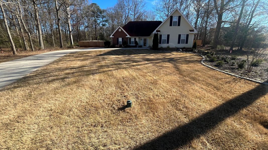 Brick home with a maintained green lawn
